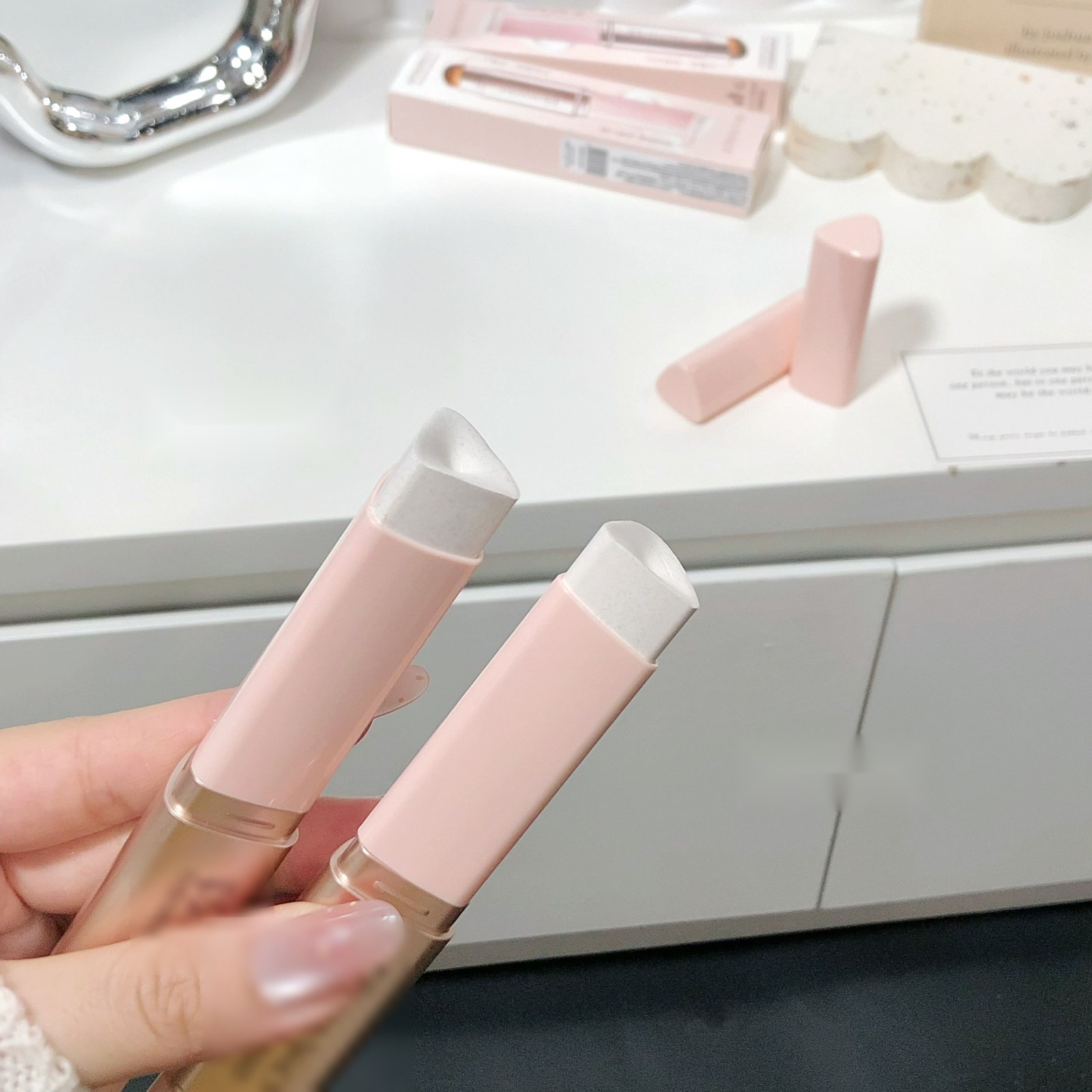 Two color-changing foundation stick variants with identical white cream tips