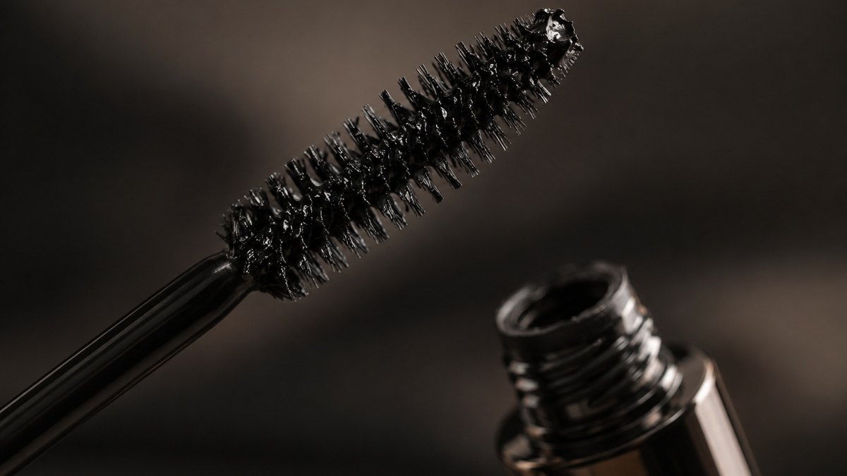 Close-up of mascara wands, eyeliner tips, pressed eyeshadow pans and brow products side by side