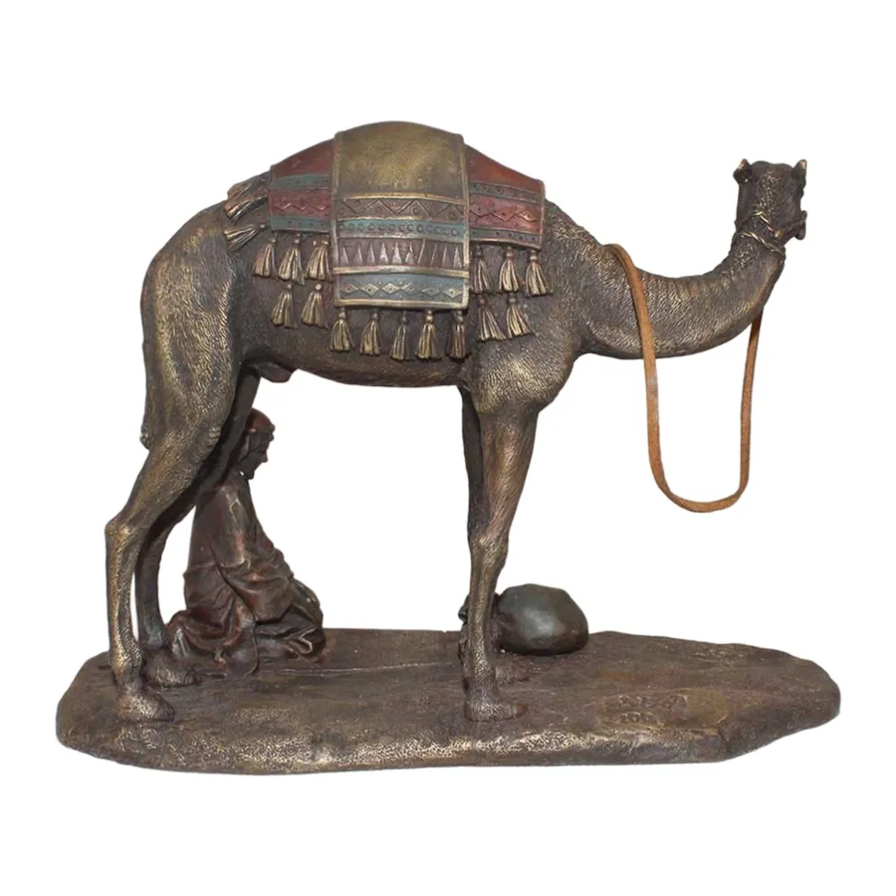 Hand-cast bronze camel sculpture with resting figure, tasselled saddle blanket detail