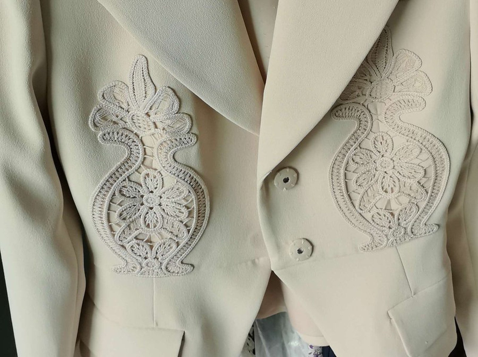 Lace applique and button detail on a tailored blazer made at our Shenzhen factory