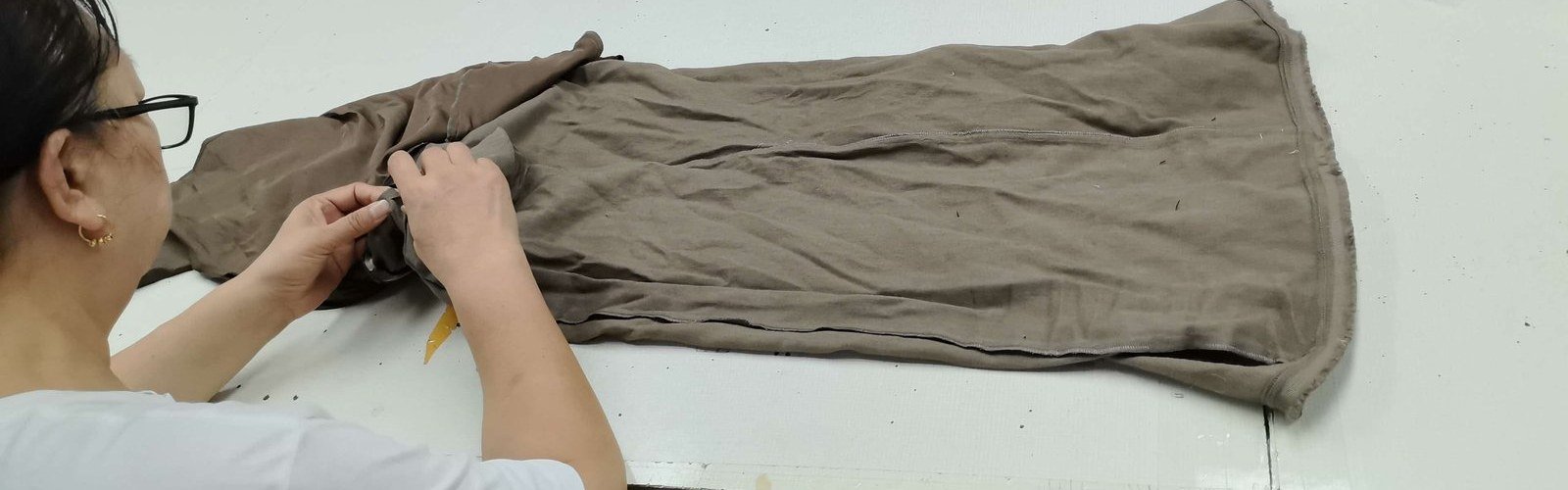Inspector checking seams at our Shenzhen factory inspection table