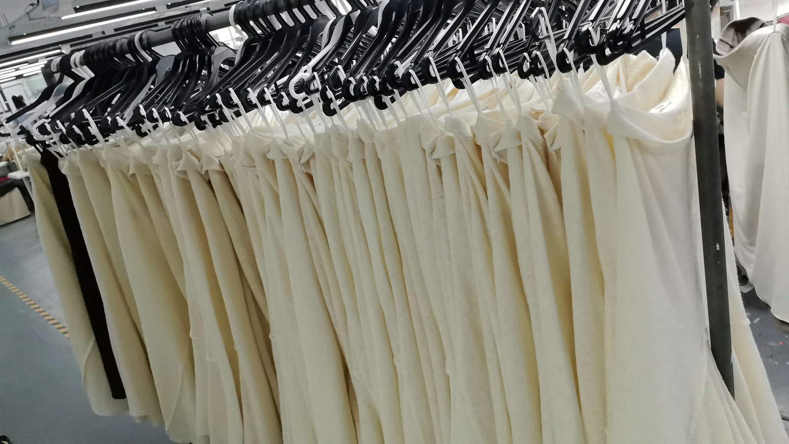Finished garments on racks in clothing factory, order completion