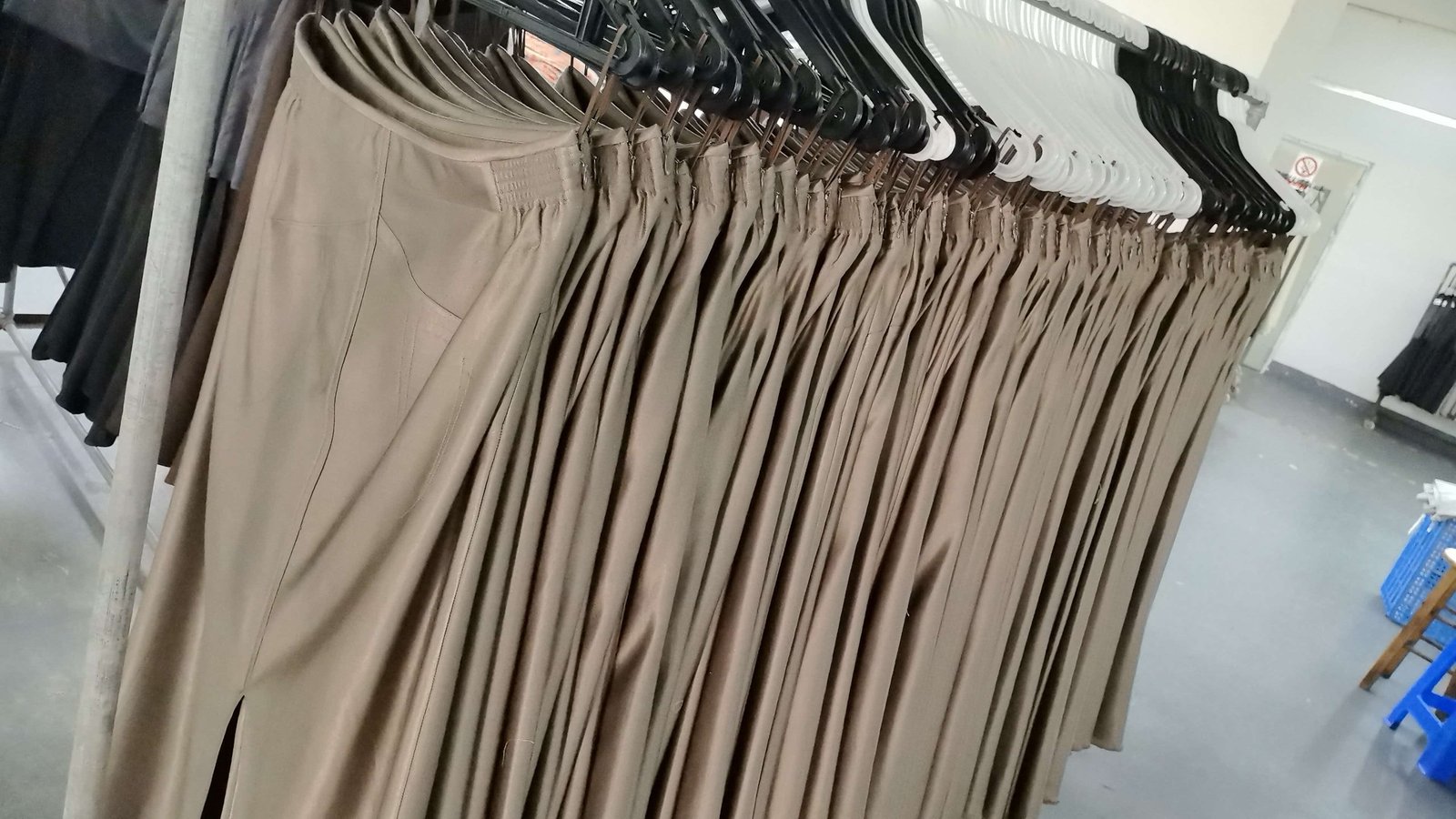 Finished garments on production racks at our Shenzhen factory