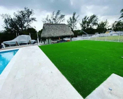Artificial turf terrace beside a garden pool