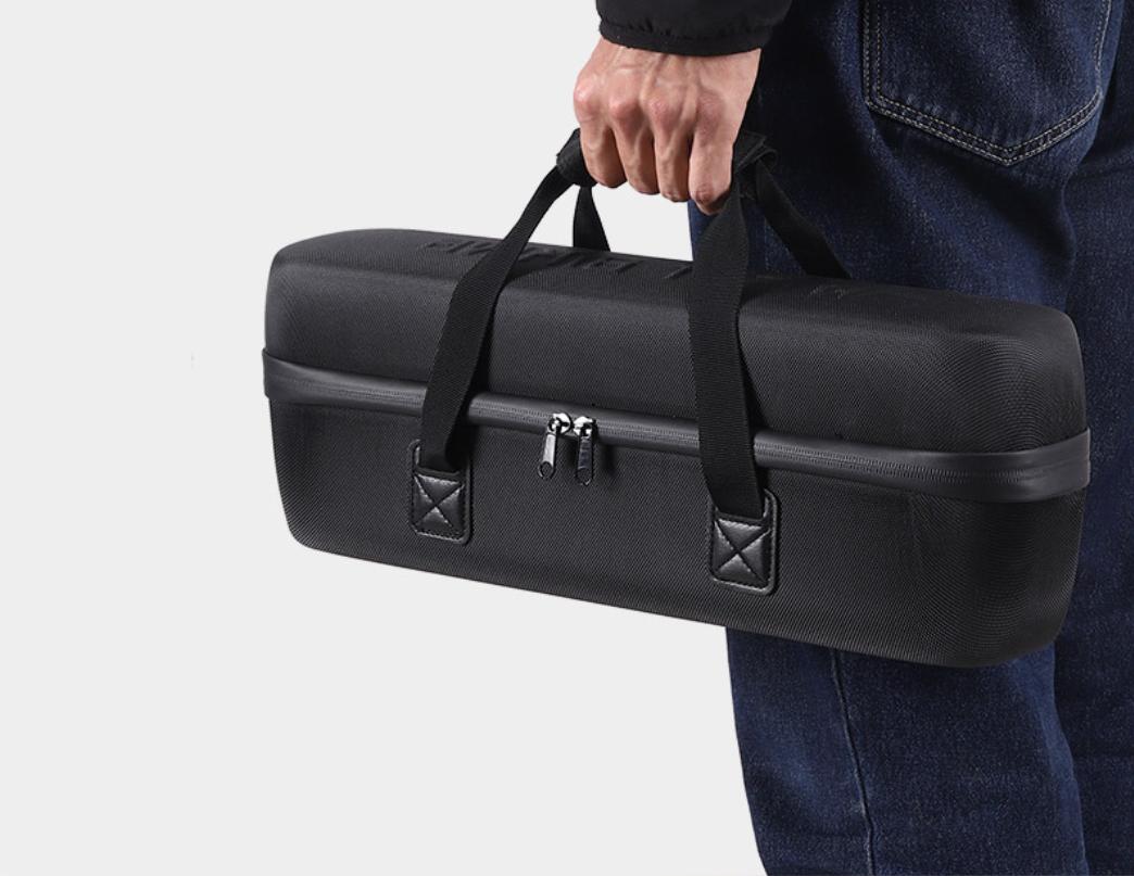 Black E01 EVA hard-shell battery bag carried by hand