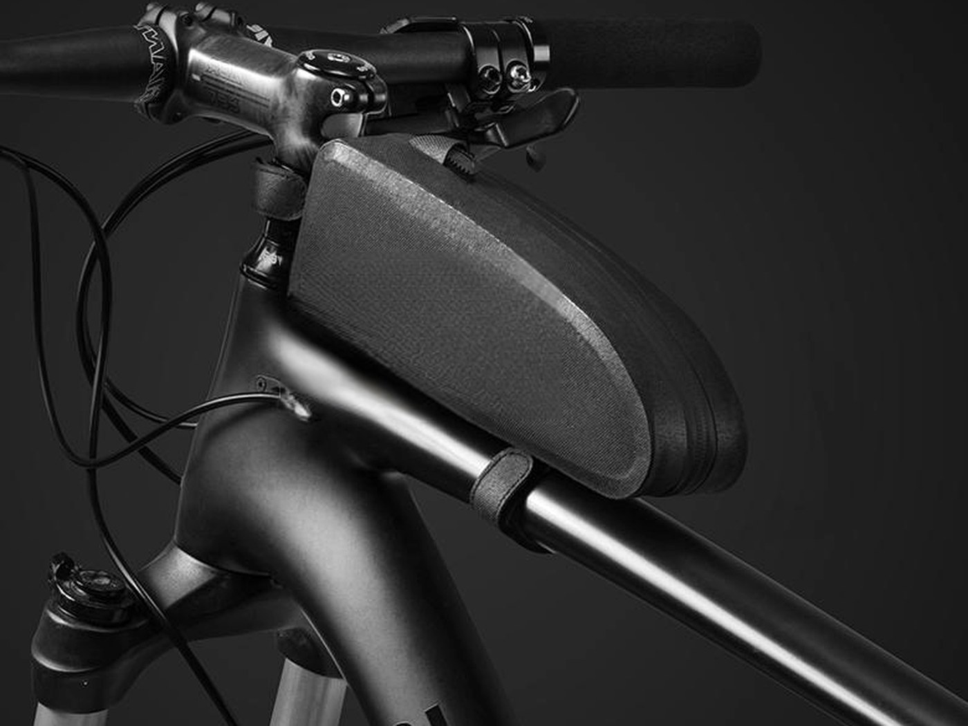 Dark grey KY017 minimalist wedge top tube bag mounted behind the stem