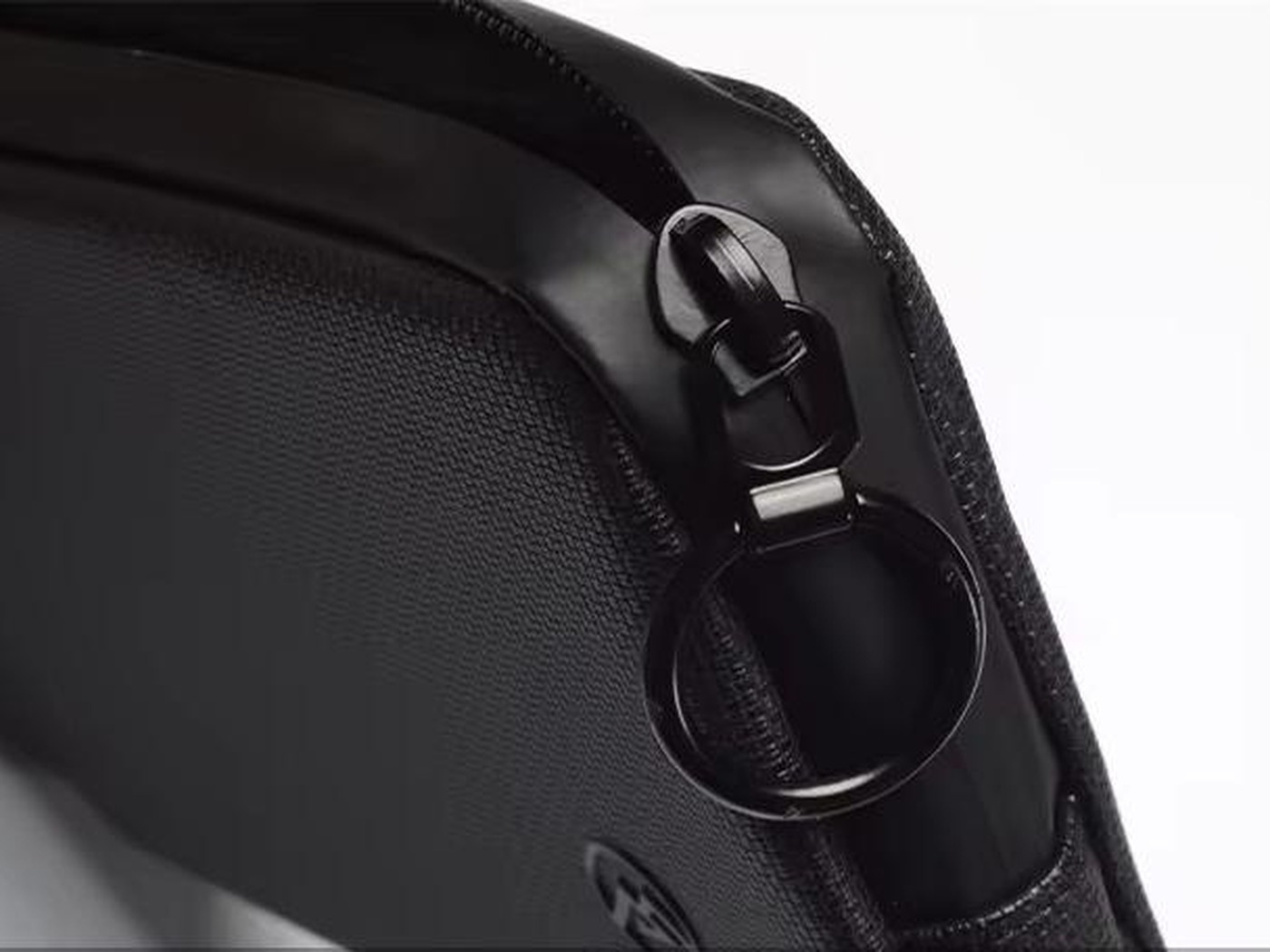 Close-up of the zipper pull and ring on a black cycling wallet