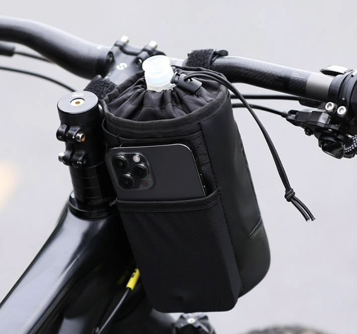 Black KY009 water bottle bag mounted on a bike handlebar, with a bottle inside and a front pocket holding a smartphone