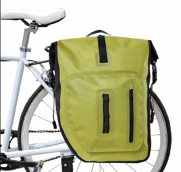 Green waterproof pannier bag mounted on a rear rack