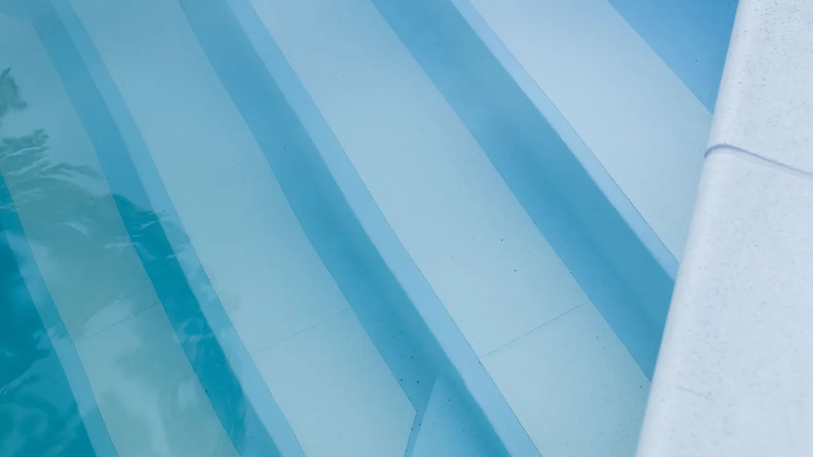 Submerged swimming pool steps showing the tread surfaces and changes in depth