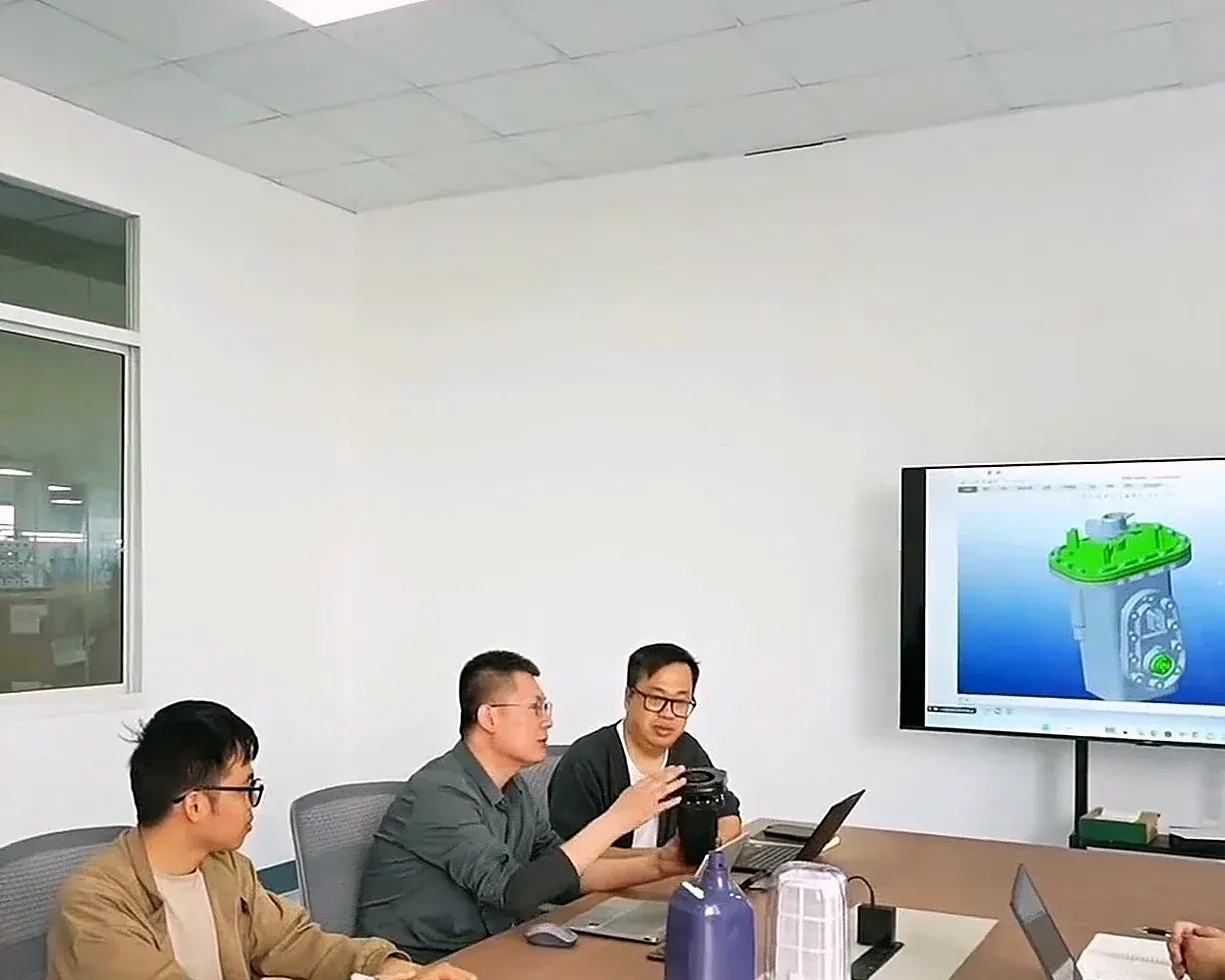 Silver Home engineers reviewing a pool robot design in an R&D meeting