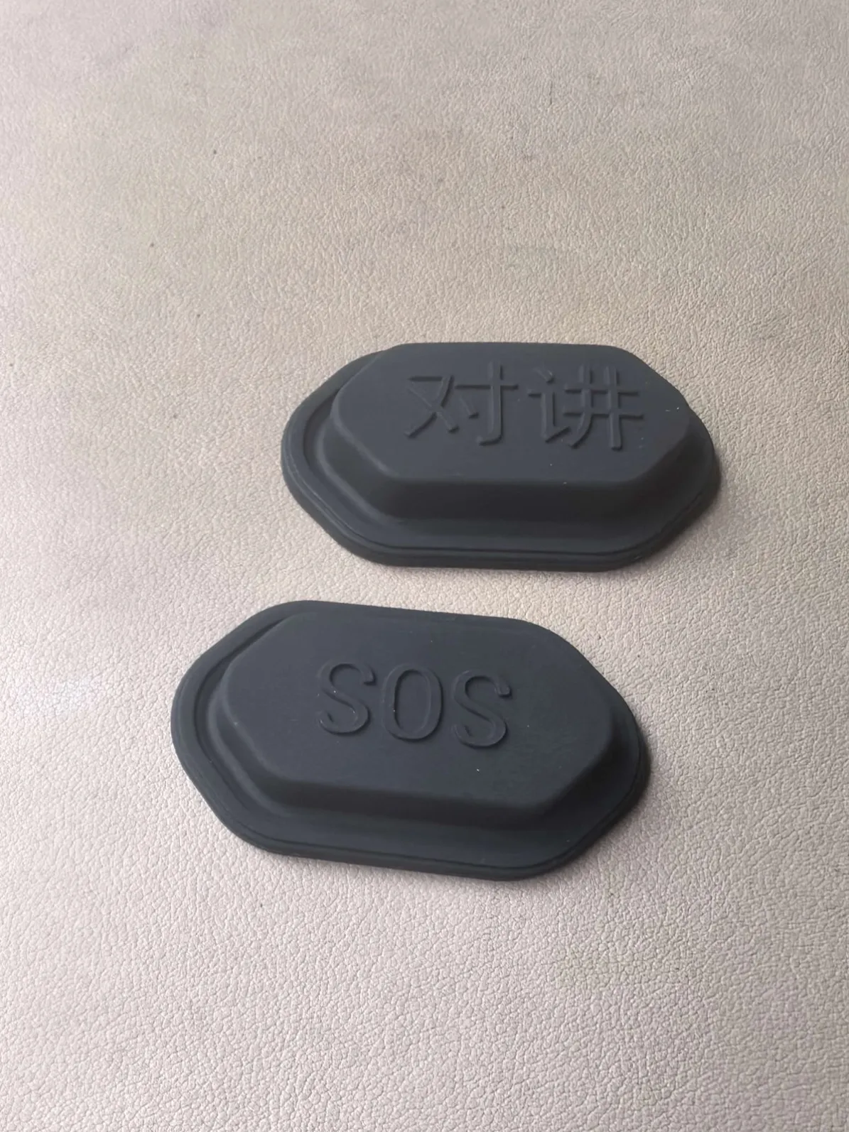 Molded rubber intercom button cap with raised legend