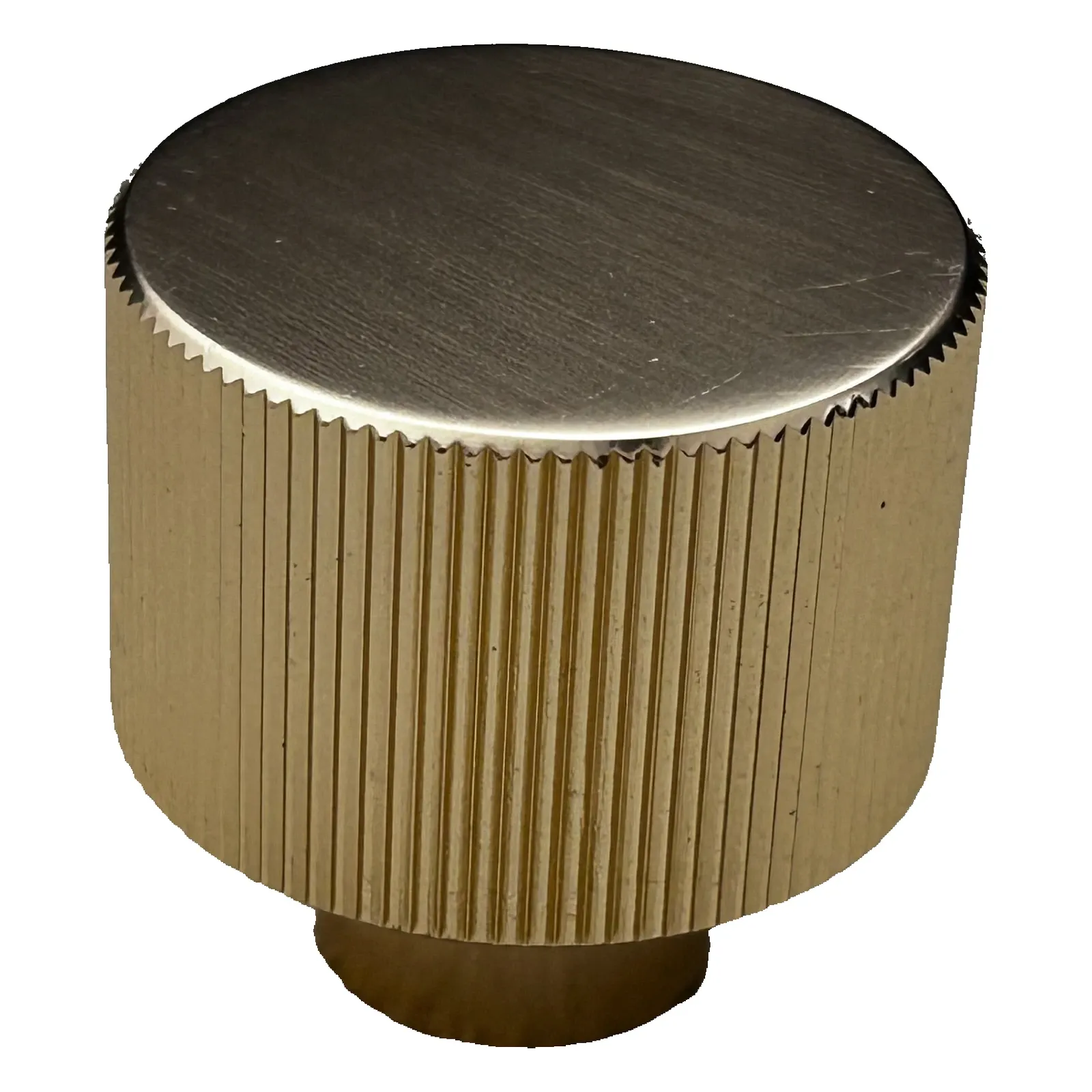 Angled view of a single textured round aluminum knob in Brush Gold highlighting the linear brushed top face and vertical side linework on a white background