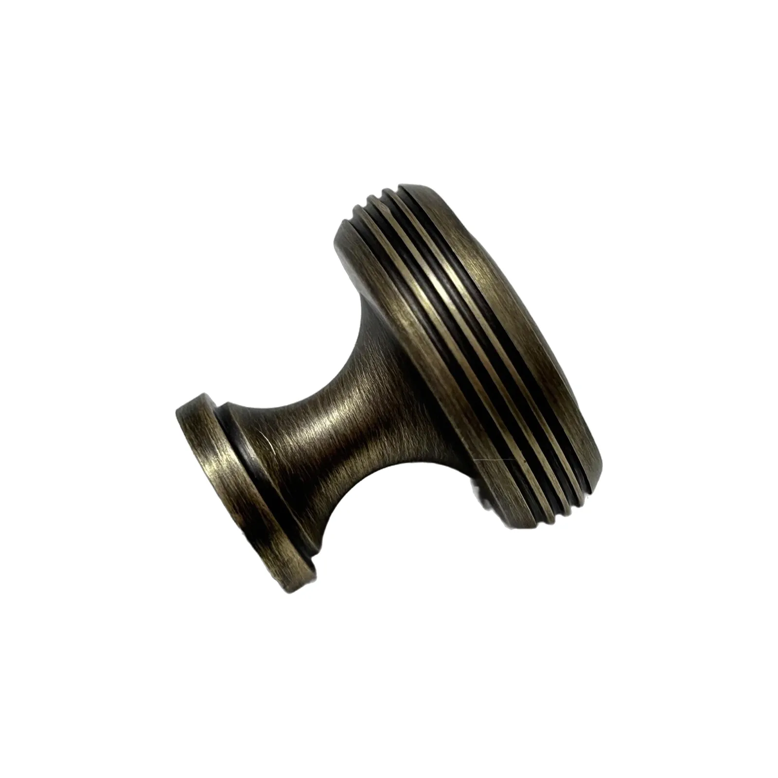 Angled view of a bronze concentric-ring brass knob tipped to show the textured edge profile and stem, on a white background