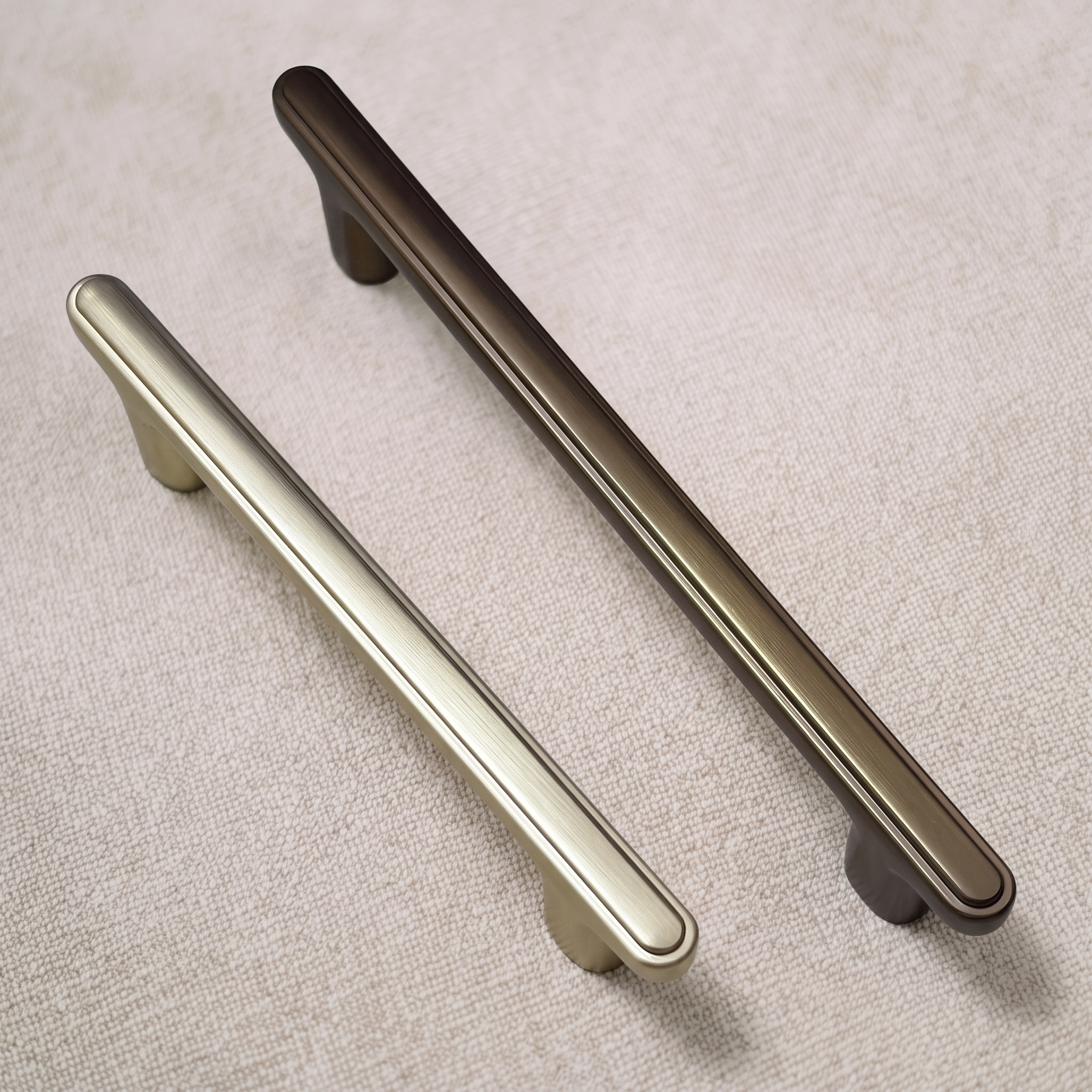 Brush Gold and Coffee ridge-top bridge pulls angled to reveal the raised ridge line along each top face