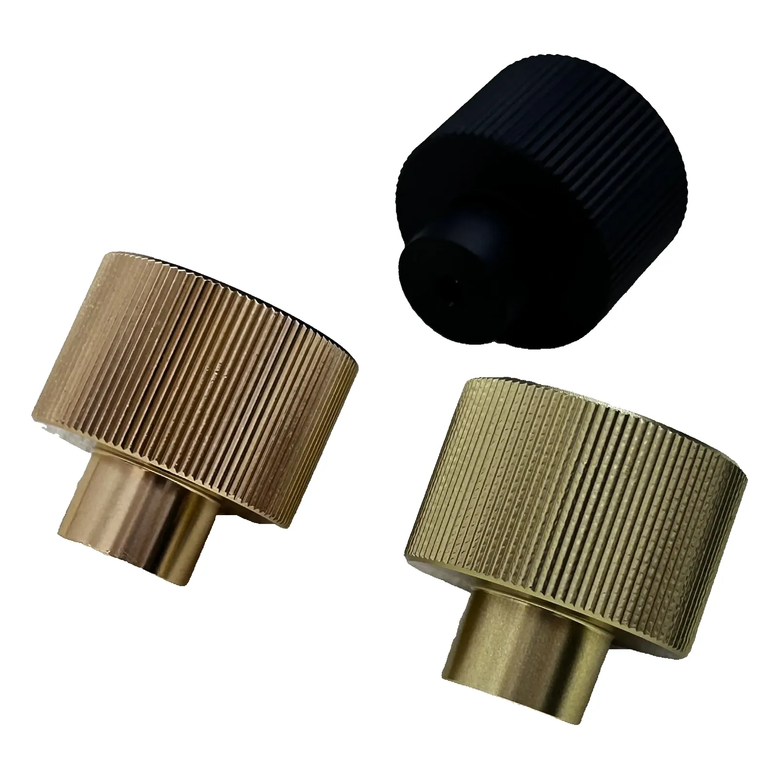 Angled view of three textured aluminum cabinet knobs arranged at a tilt revealing the short mounting stem on a white background