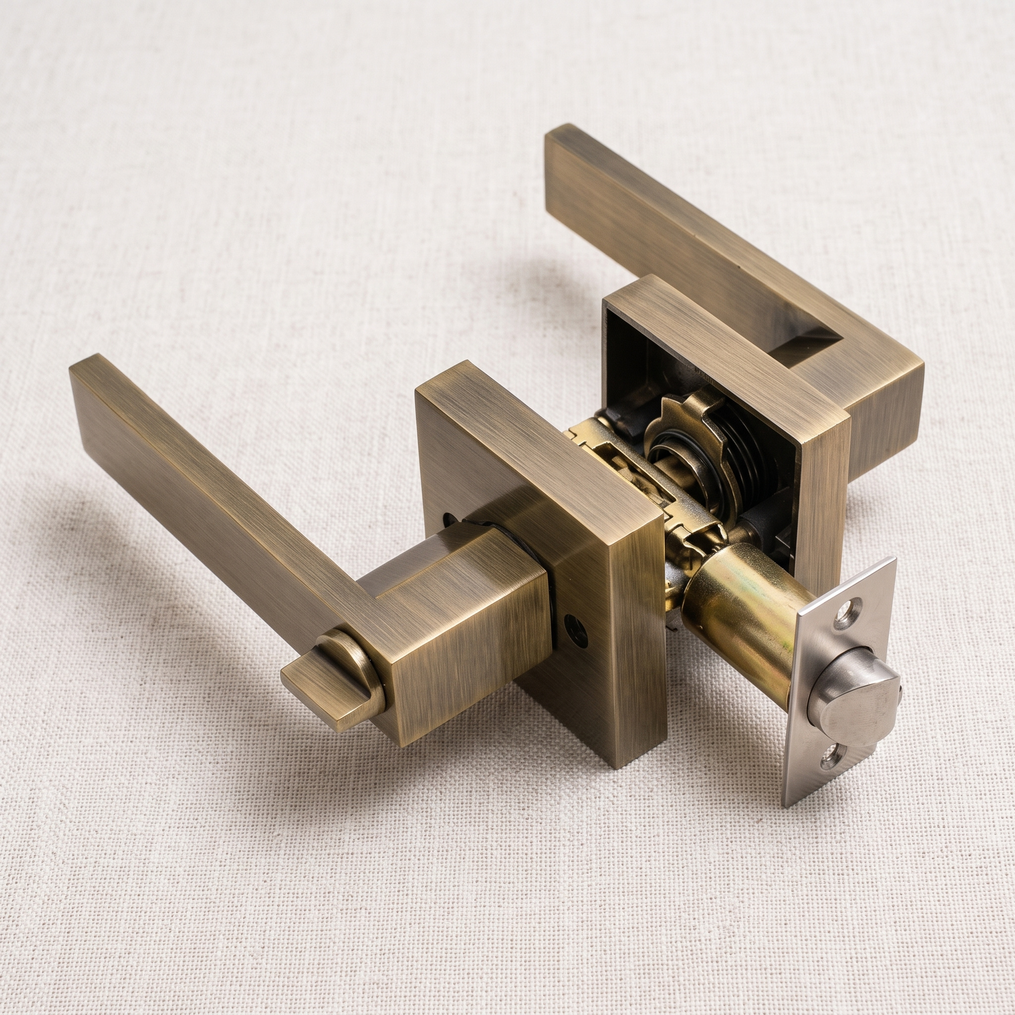 Angled view of a copper square-rose keyed door handle lock with its latch, on a pale linen surface