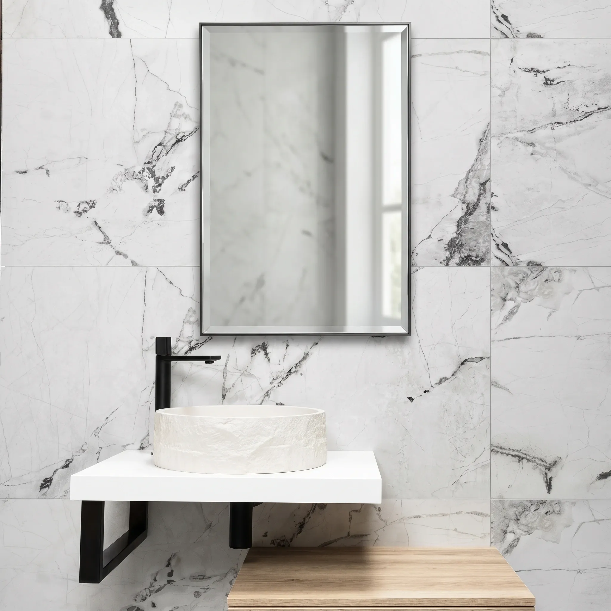 Black framed rectangular mirror above a round stone vessel sink on a white wall-hung counter with grey veined marble wall tiles