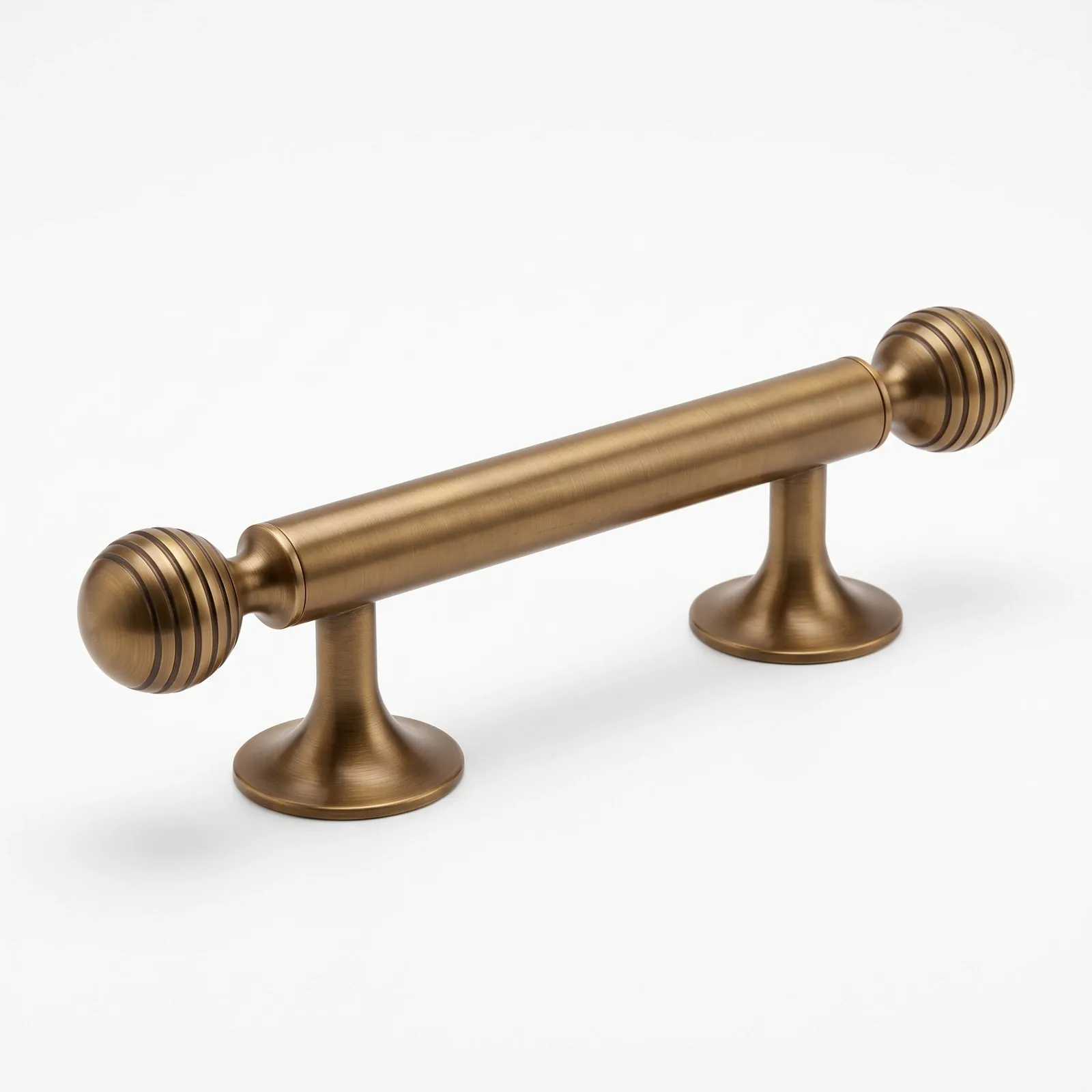 Brass Gold bar pull in close view showing the grooved ball ends and bell-shaped bases.