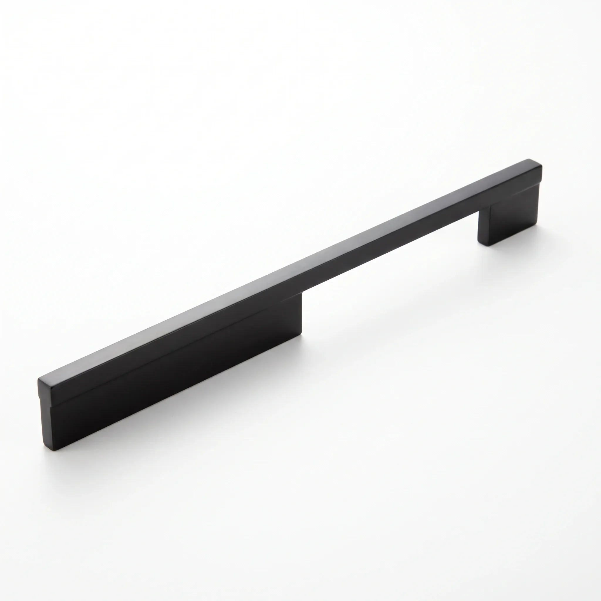 Angled view of a dark square-profile cabinet pull with a recessed longitudinal groove running along the bar