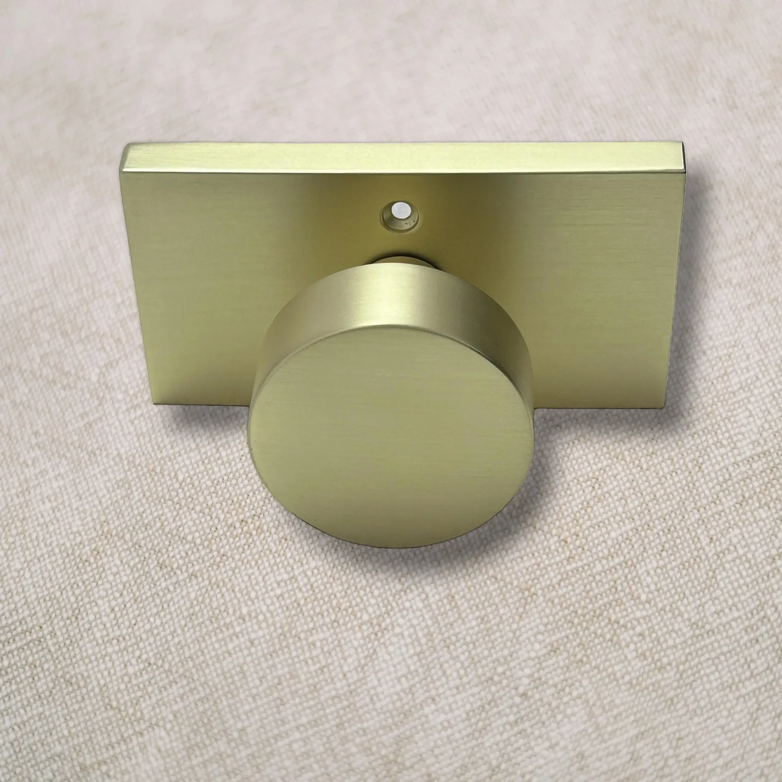 Brushed gold zinc alloy door knob with rectangular rose plate, front view