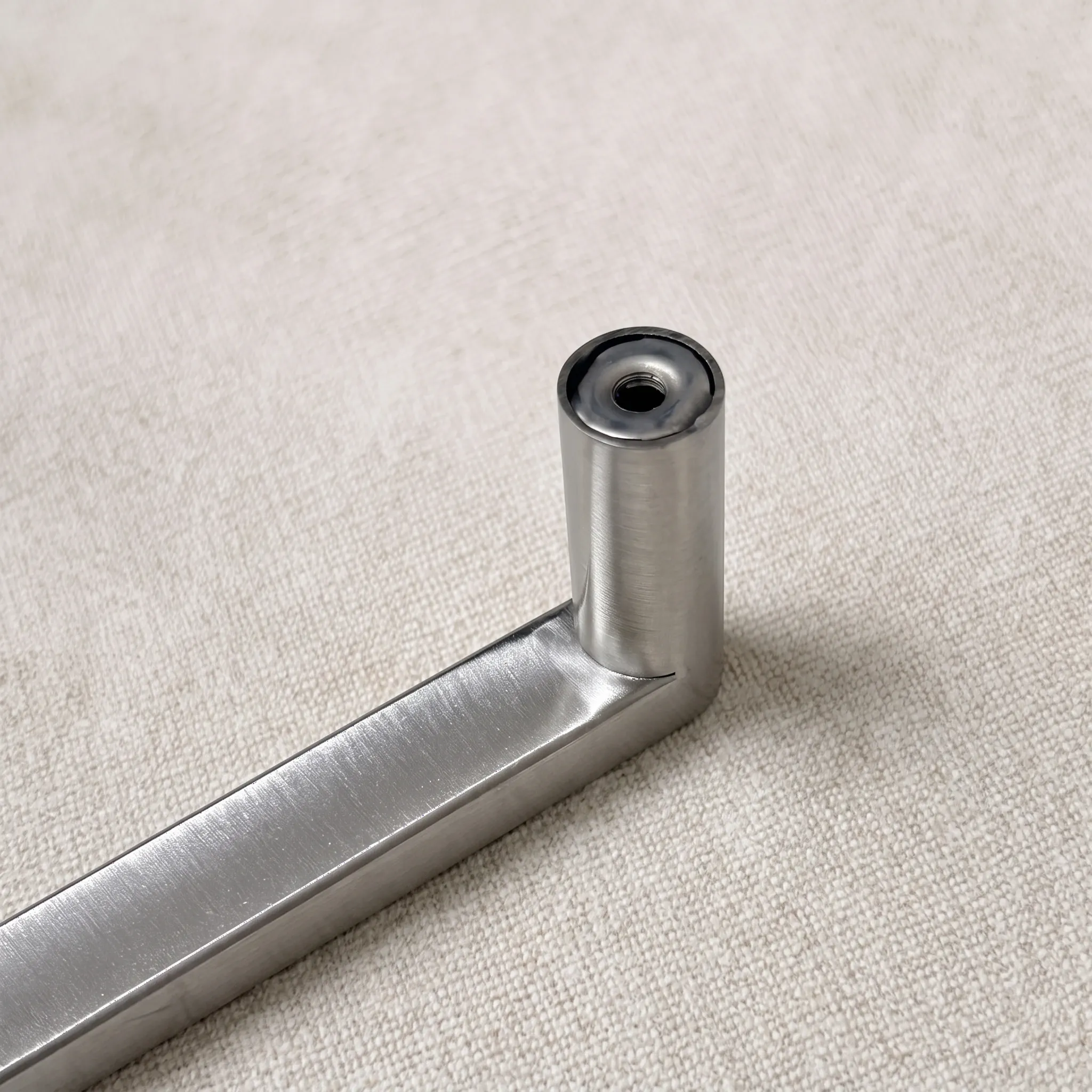 Macro view of the round leg end on linen, showing the annular wall ring around the central fixing bore