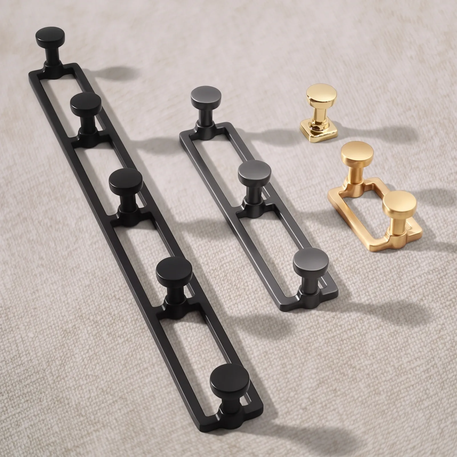 Zinc alloy hook series in Matt Black, Gunmetal, Brass Gold and Mirror Gold: five-hook, three-hook and two-hook rails with a single hook on a linen backdrop