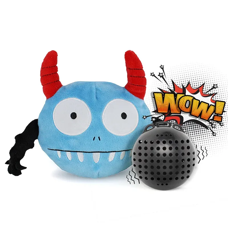 Blue monster-shaped dog ball with red horns beside a black sound ball