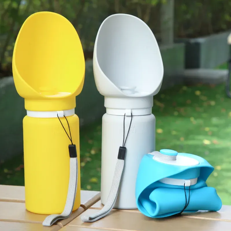Foldable dog water bottles in yellow, white and blue on an outdoor table