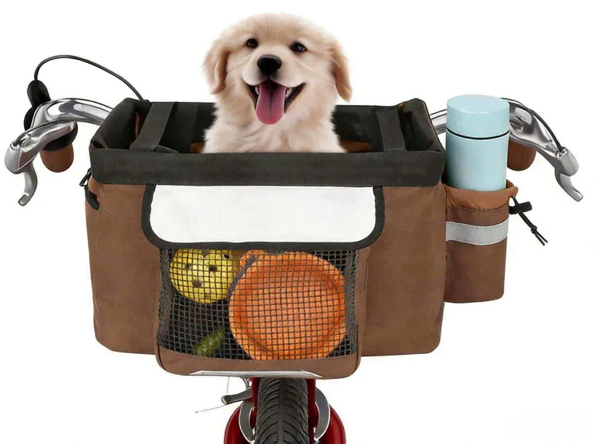 Brown pet bicycle basket with a puppy inside, mounted on handlebars beside a cup holder