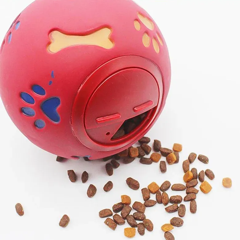 Red treat dispensing dog ball with kibble spilling out