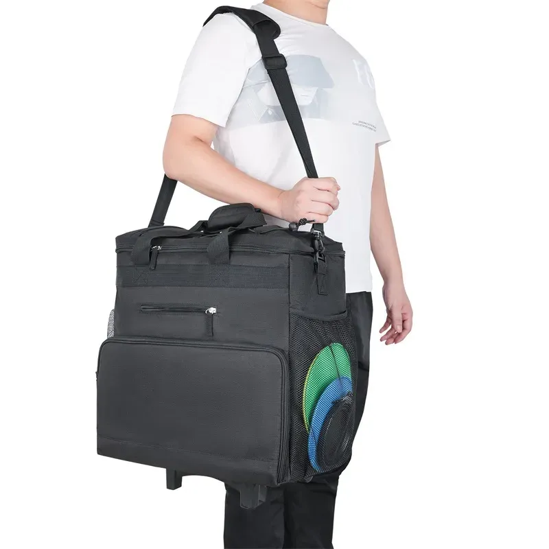 Person carrying the black rolling pet travel bag by its shoulder strap