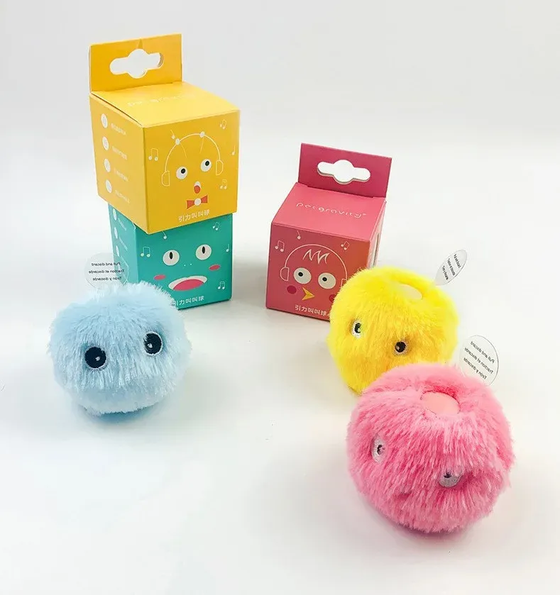 Plush squeaky cat toy balls in blue, yellow and pink with colourful packaging boxes