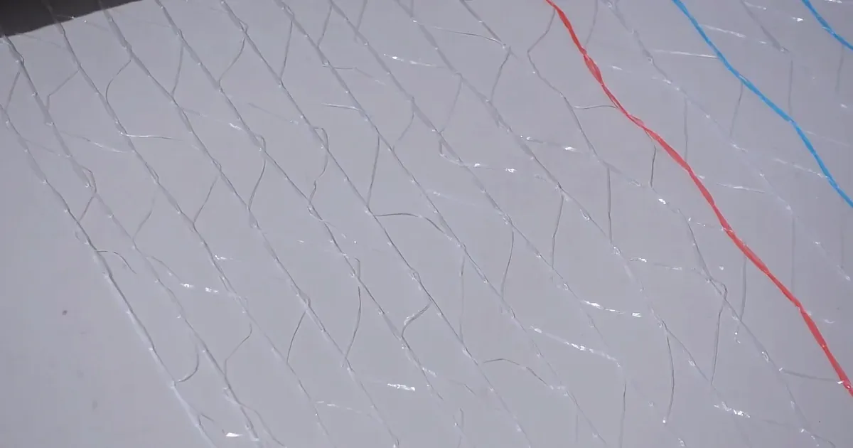 Close-up of white bale net wrap mesh with red and blue strands