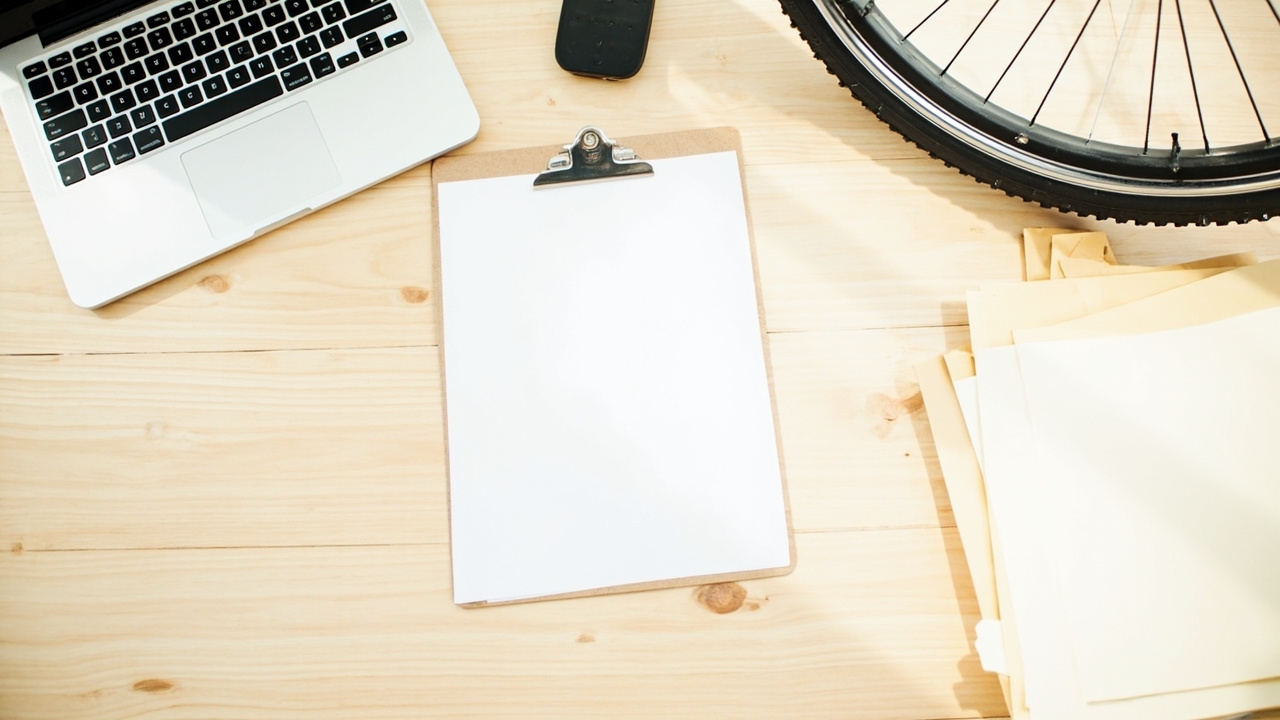 Plain import compliance folders and an electric bicycle wheel in a warehouse office