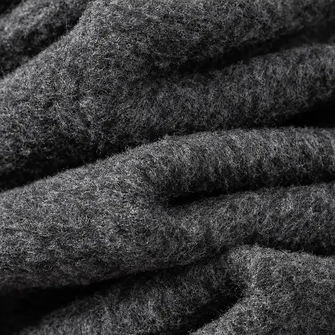 Close-up of the dense charcoal grey brushed fleece lining inside the leggings.