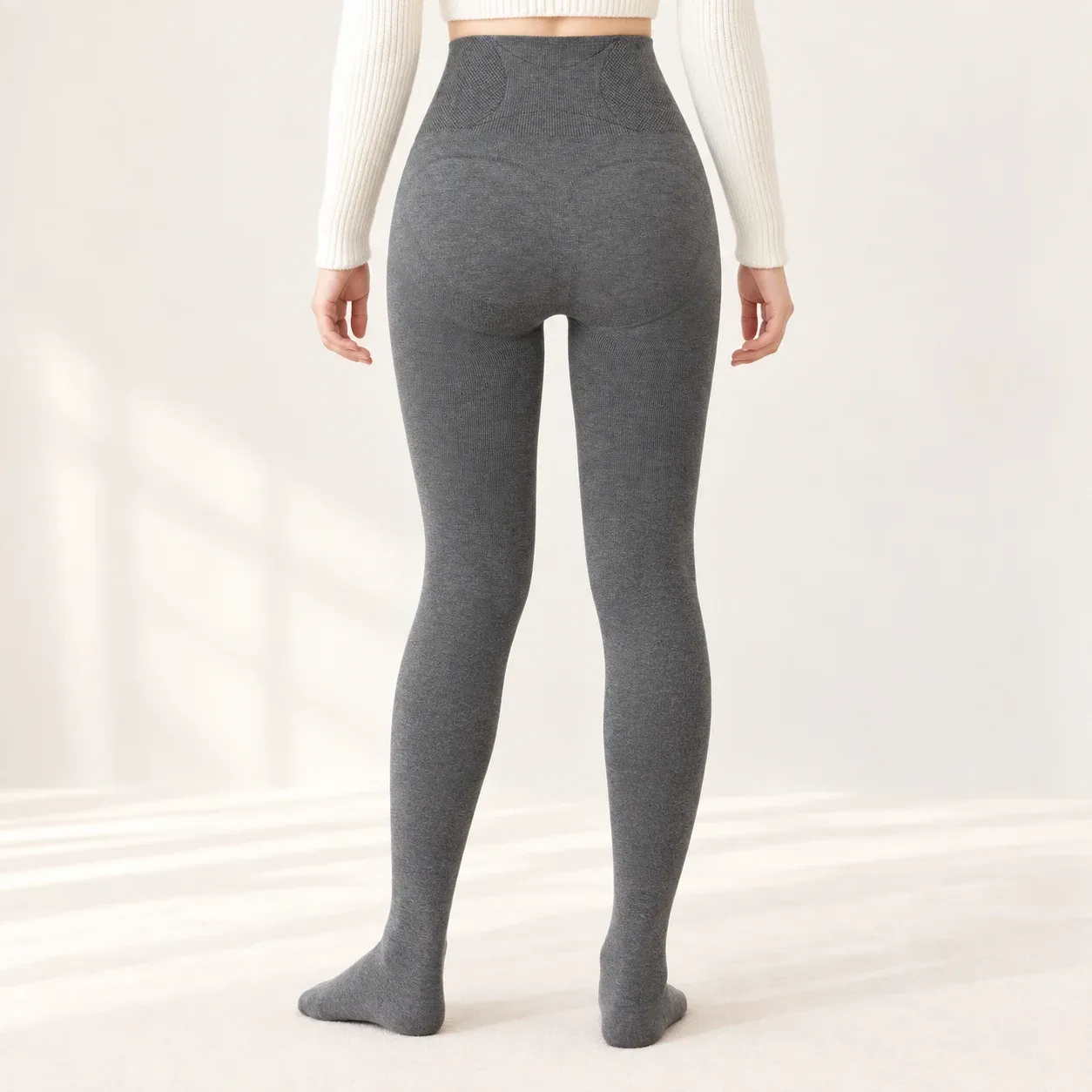 Back view of grey high-waisted fleece-lined leggings showing the waist, seat and leg fit