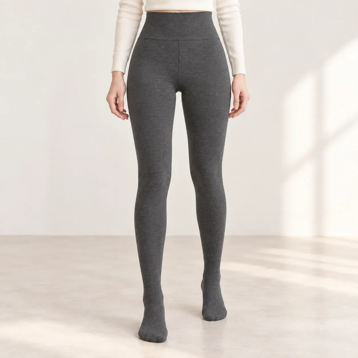 Front view of grey fleece-lined leggings with a wide high waistband and enclosed feet