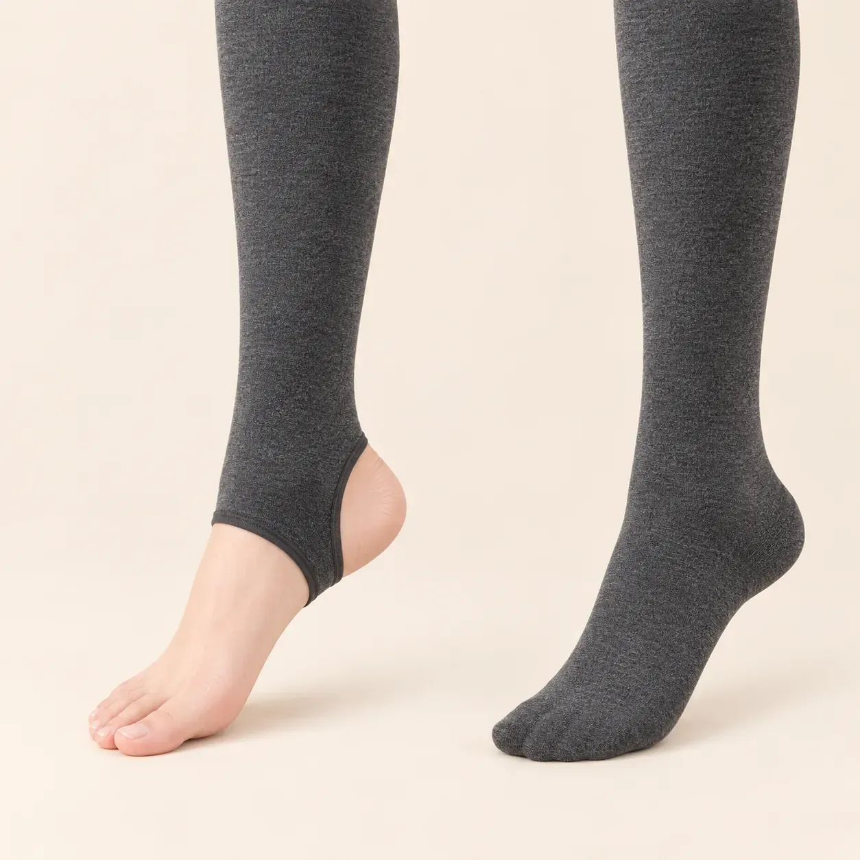 Charcoal grey leggings showing the open-heel stirrup option on the left and fully enclosed footed option on the right.