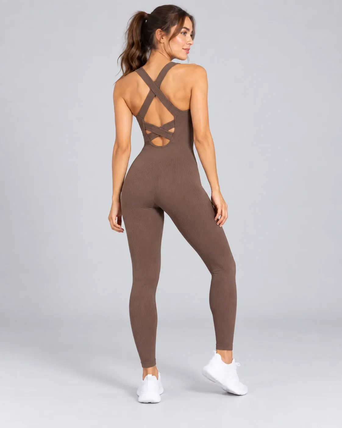 Women's brown seamless full-length unitard with cross-back cutout straps, back view