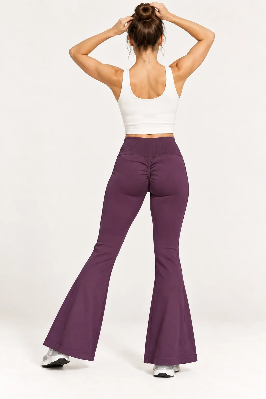 Women's burgundy seamless flare leggings shown from the back in a natural movement pose