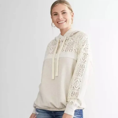 Front view of a cream hoodie with lace trim panels and drawstring hood