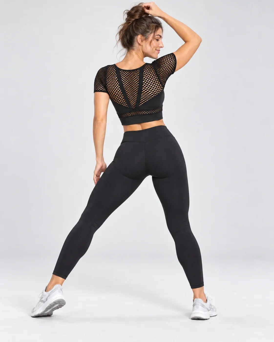 Women's black seamless mesh long-sleeve crop top, back view