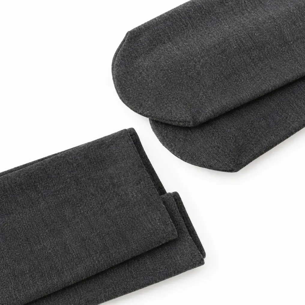 Close-up of enclosed-foot and ankle-length hem options for grey fleece-lined leggings