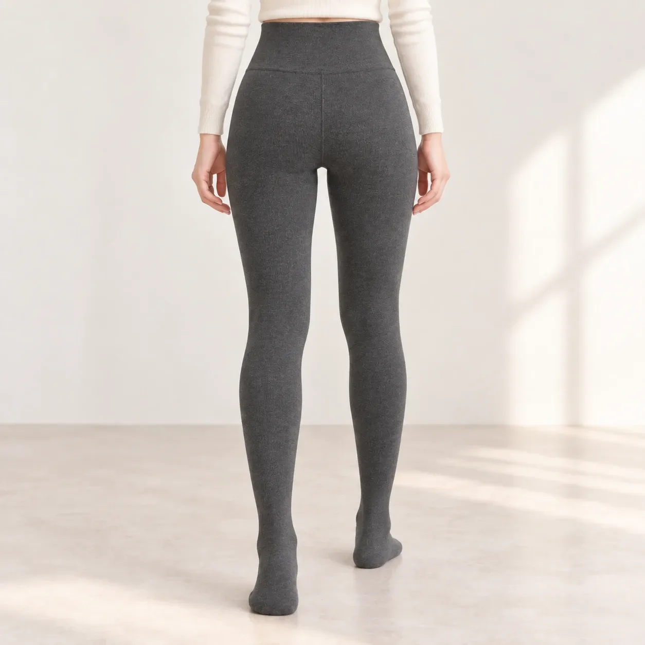 Back view of grey fleece-lined leggings showing the wide waistband, center seam and full leg fit