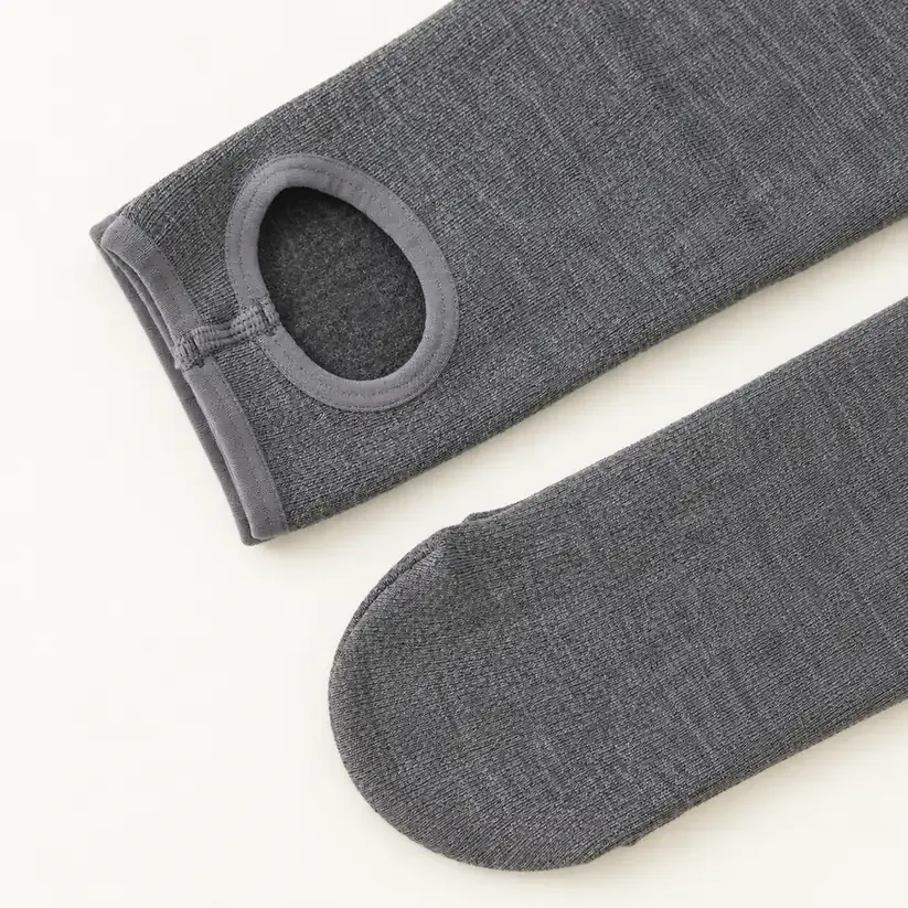 Close-up of stirrup and enclosed-foot options for grey fleece-lined leggings