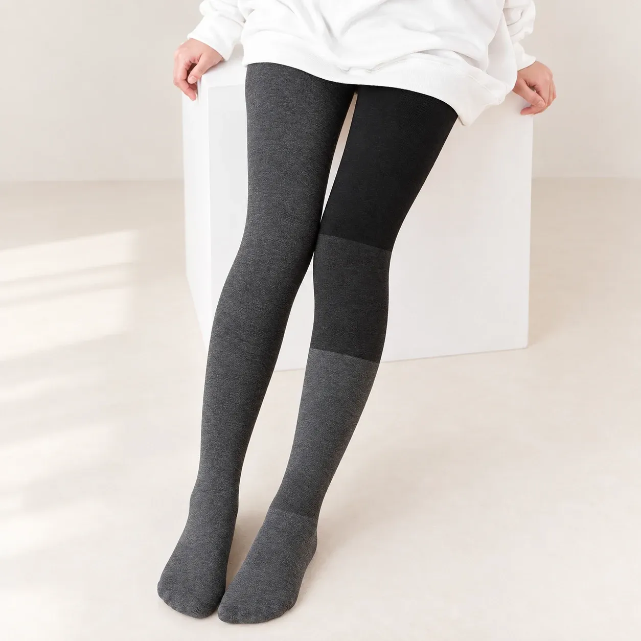 Grey fleece-lined leggings showing the outer fabric beside an inside-out leg with three pressure zones
