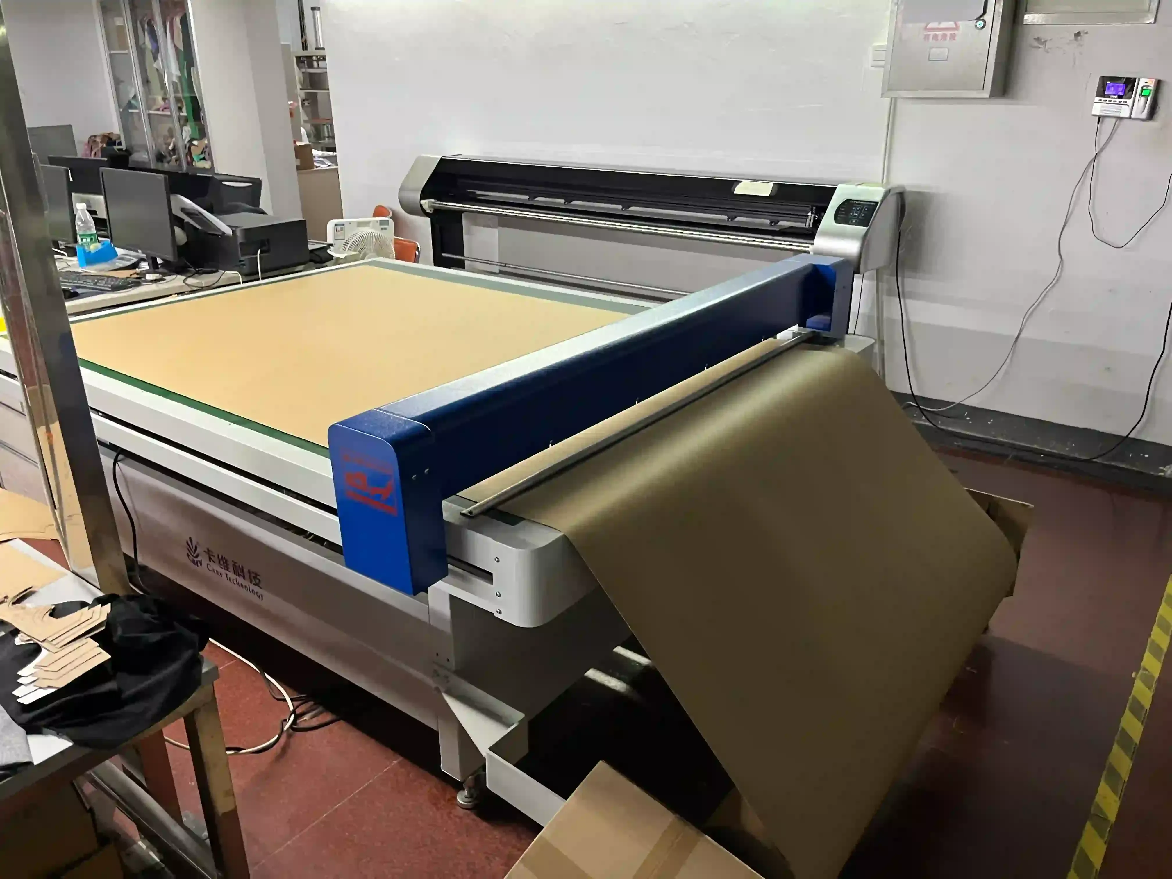 Automated fabric cutting machine processing layered fabric in the knitting factory