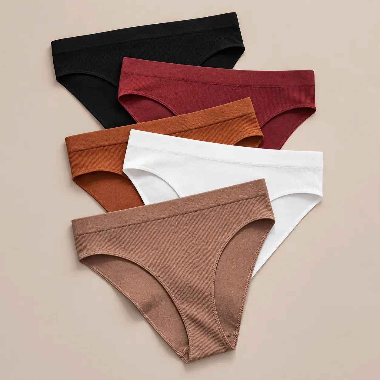 Multiple colors of seamless ribbed bikini briefs showing different color options and knit texture for custom underwear manufacturing