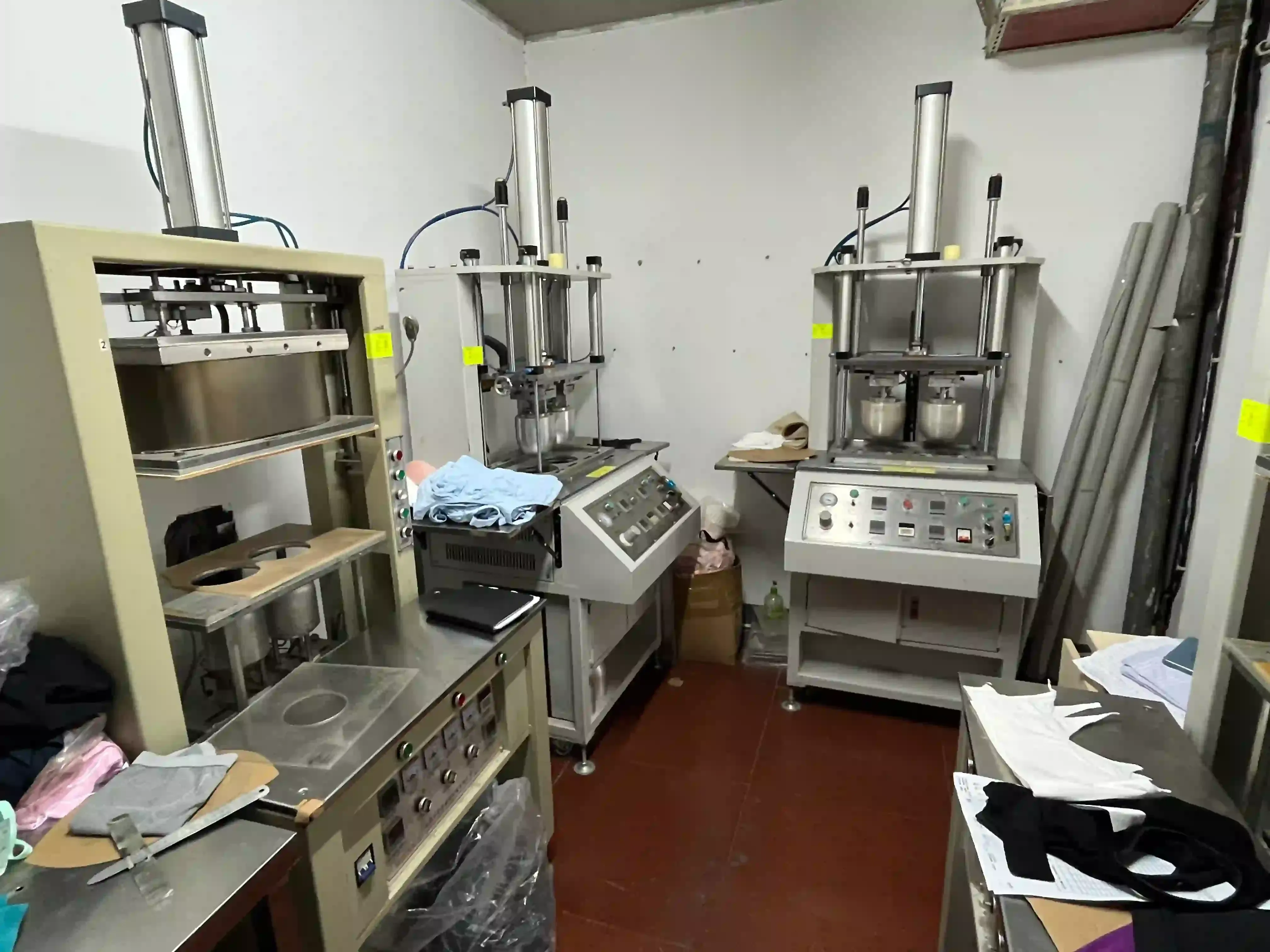 Heat press machines set up at a finishing station in the knitwear factory